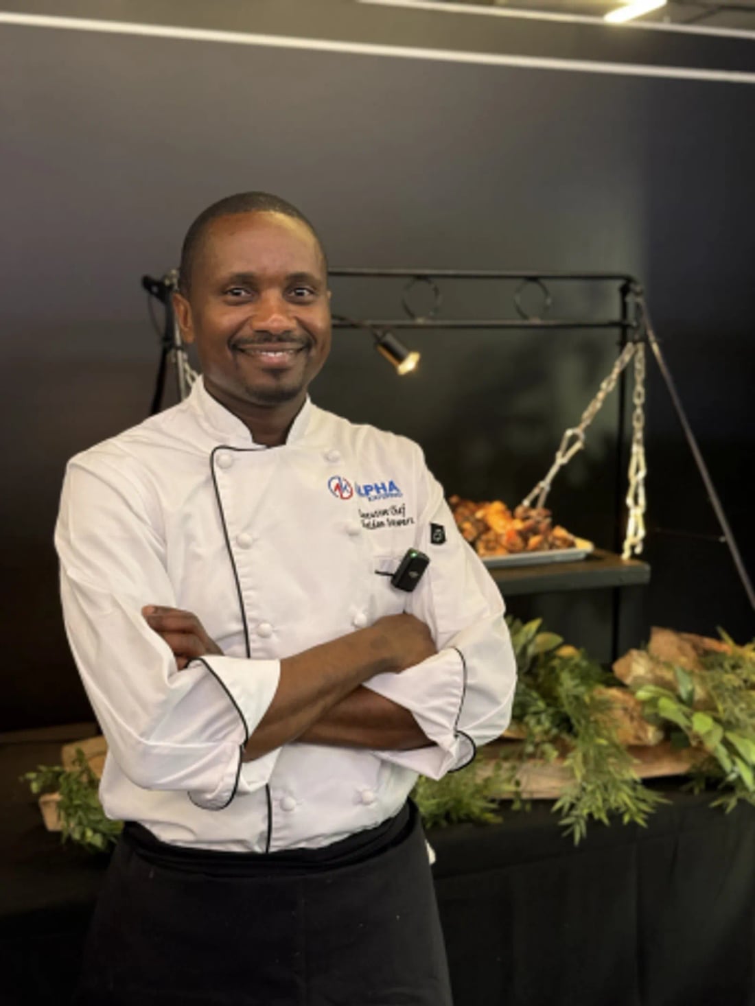 Alpha Katering's executive chef standing in front of a catering display