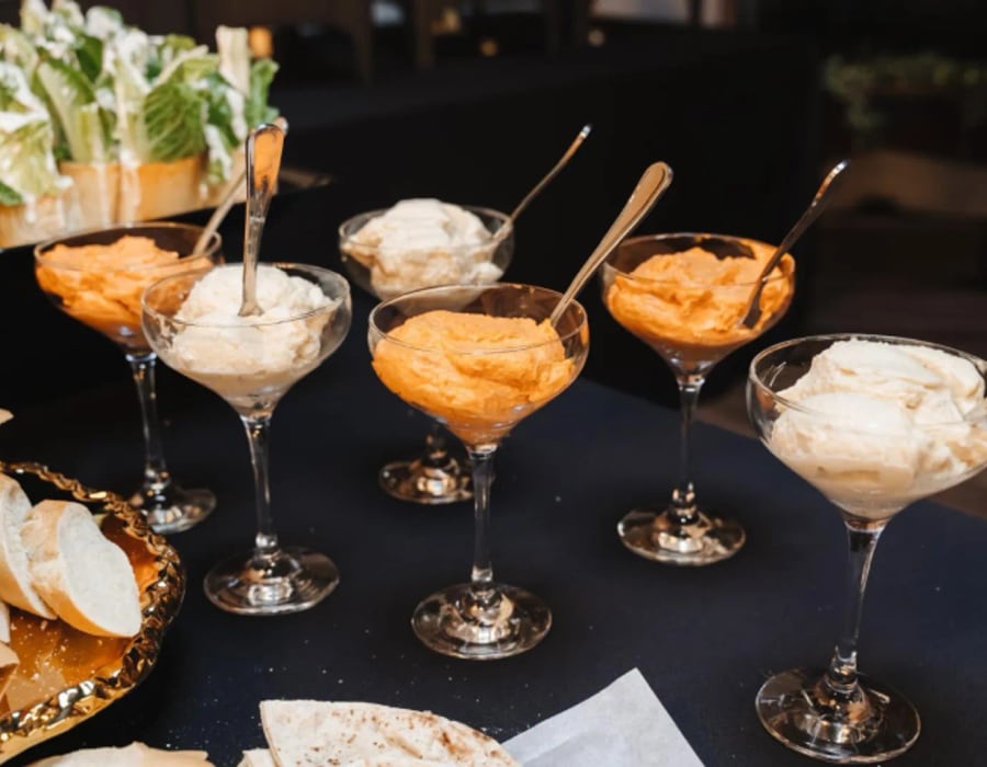 Individual parfait glasses on a dessert table