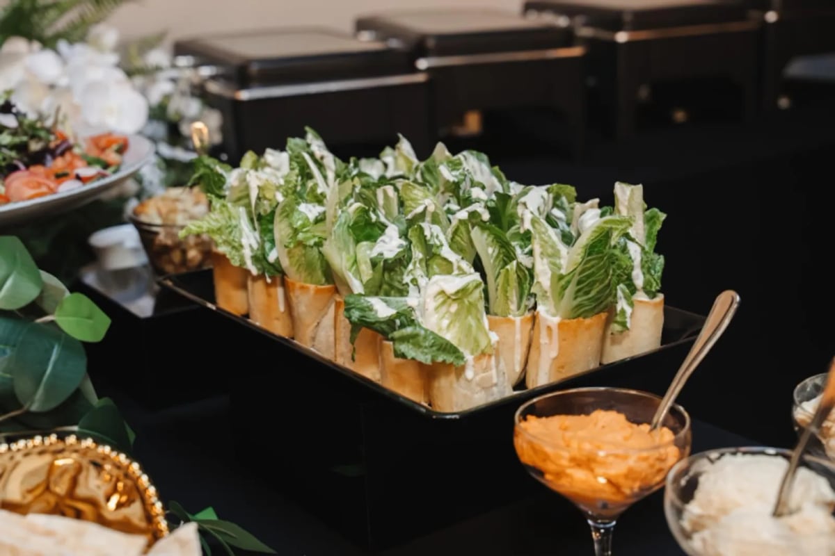 Caesar salad boats served in baguette cups